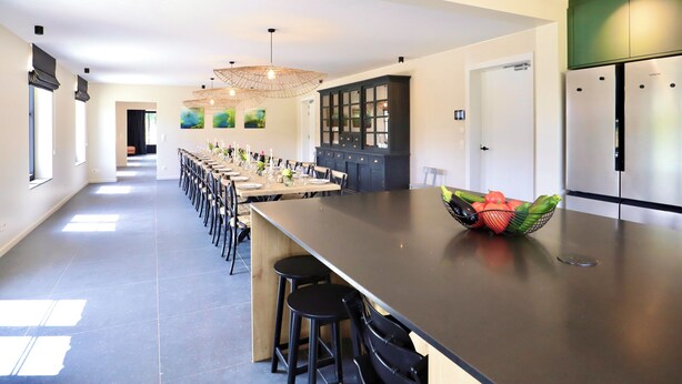 A modern kitchen with a long island, dark cabinetry, and a Siemens refrigerator. - Ferme Valentour 24 beds, ideal for families and corporate seminars. (Gesves)