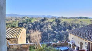 A rural landscape with a view of distant hills, a stone wall, and a building with a tiled roof. - Palazzo Bonaccorsi in the historic center with panoramic view (Colle di Val d'Elsa)