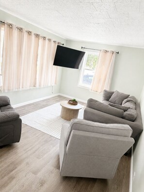 A living room with a sofa, a coffee table, and a flat-screen TV mounted on the wall. - NEW-Pictured Rocks Paradise!
Near Pictured Rocks & Lake Superior! (Shingleton)