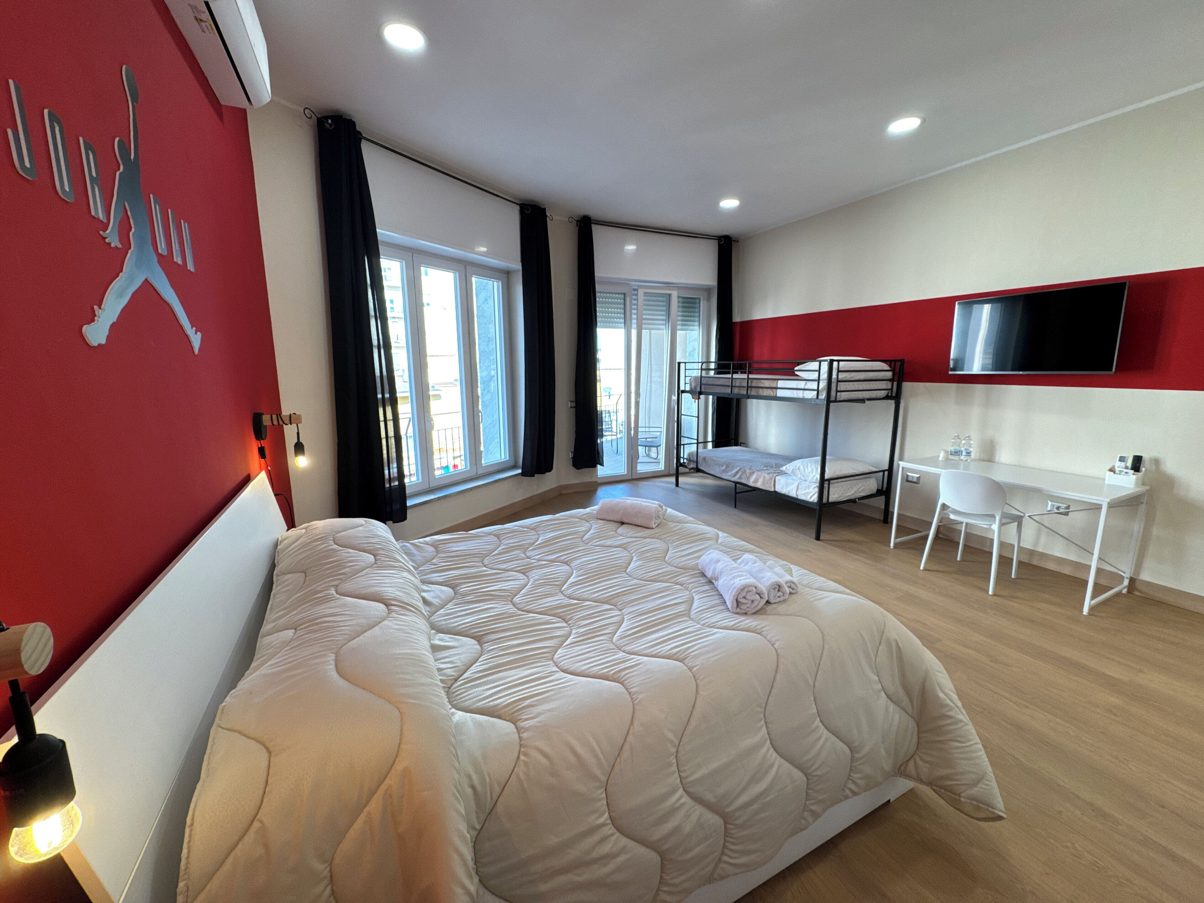 Deluxe Quadruple Room, Housekeeping, City View | Desk, laptop workspace, blackout drapes, free WiFi