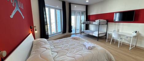 Deluxe Quadruple Room, Housekeeping, City View | Desk, laptop workspace, blackout drapes, free WiFi