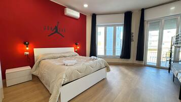 Deluxe Quadruple Room, Housekeeping, City View | Desk, laptop workspace, blackout drapes, free WiFi