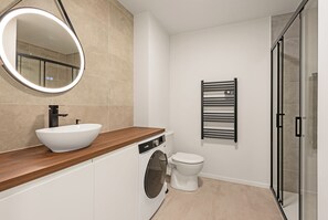 Shower, hair dryer, towels, toilet paper