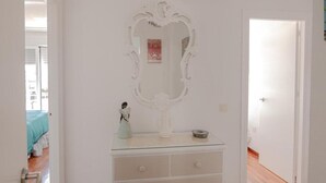 A room with a white dresser, a large mirror, and a ceiling fan. - Apartment 'Melina' with Sea View, Wi-Fi and Air Conditioning (Cala del Moral)