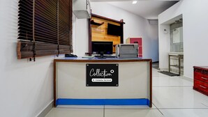 A reception desk with a sign reading "Collection Company-Serviced."