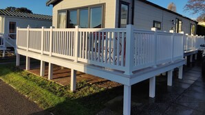 A mobile home with a white deck and a covered porch. - Rockley Park - Harbour View, No 67 (Poole)