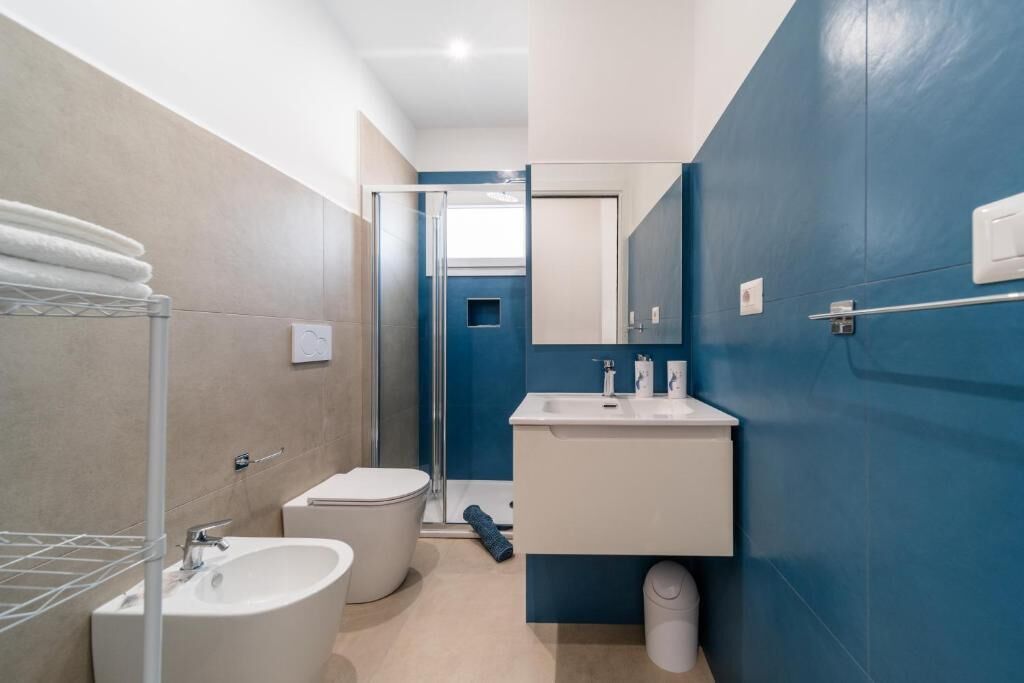 A modern bathroom with a bathtub, toilet, and sink.