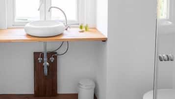 A bathroom with a white sink, wooden countertop, and a blue star-patterned floor.