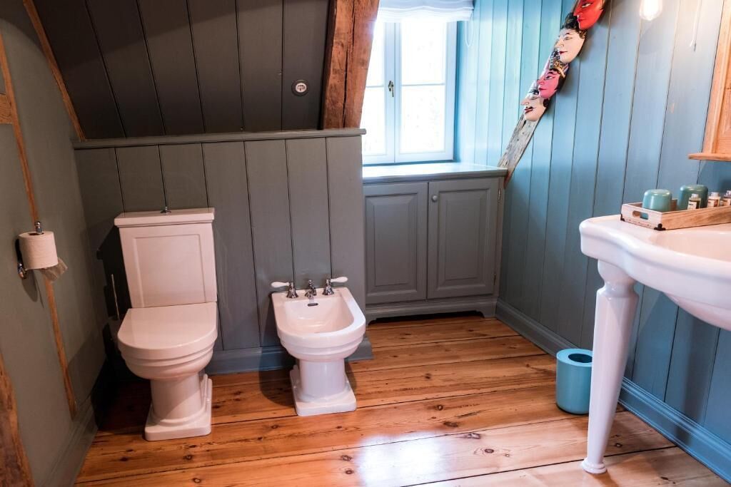 A bathroom with a toilet, bidet, and sink.