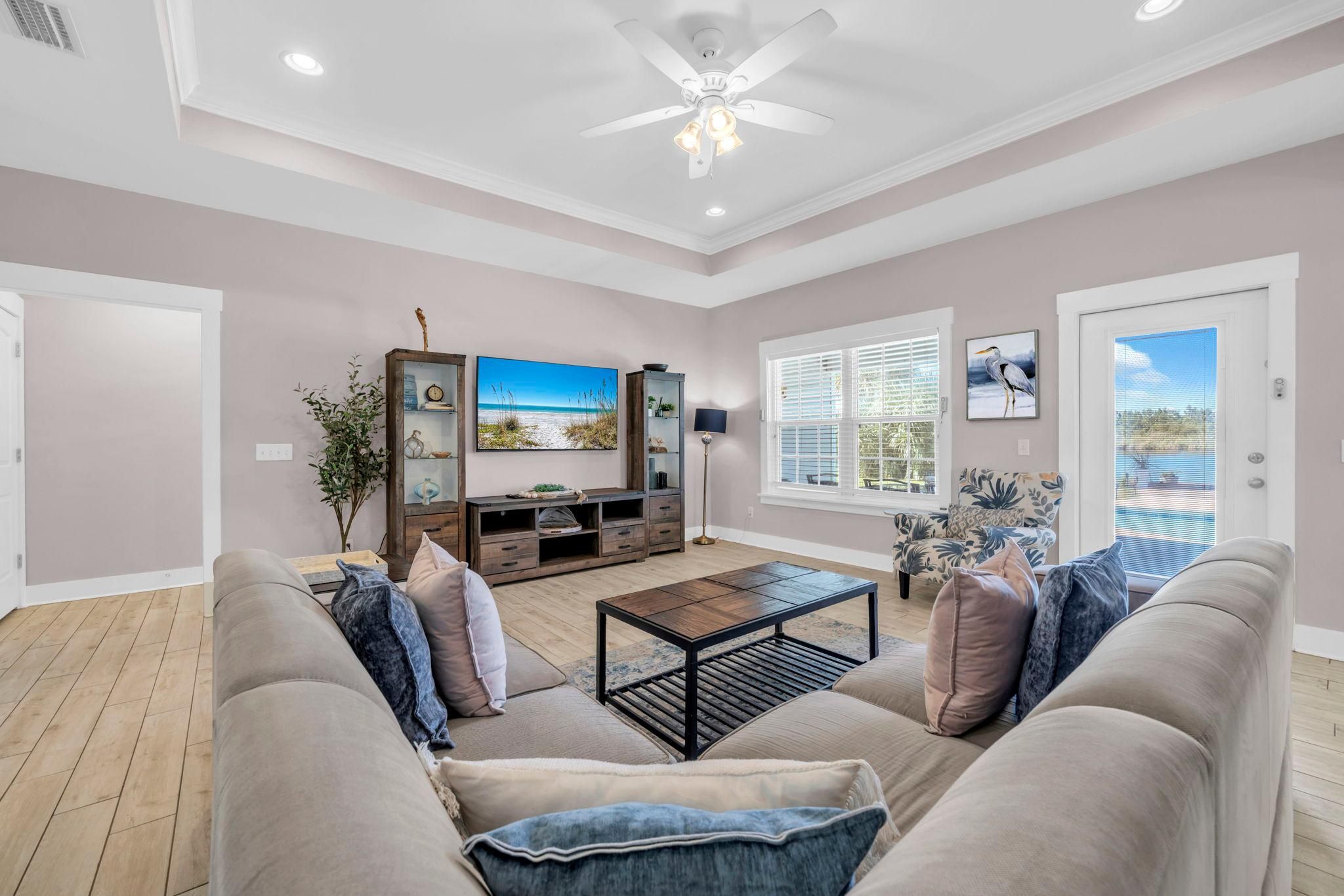 A living room with a sofa, coffee table, and a TV stand.