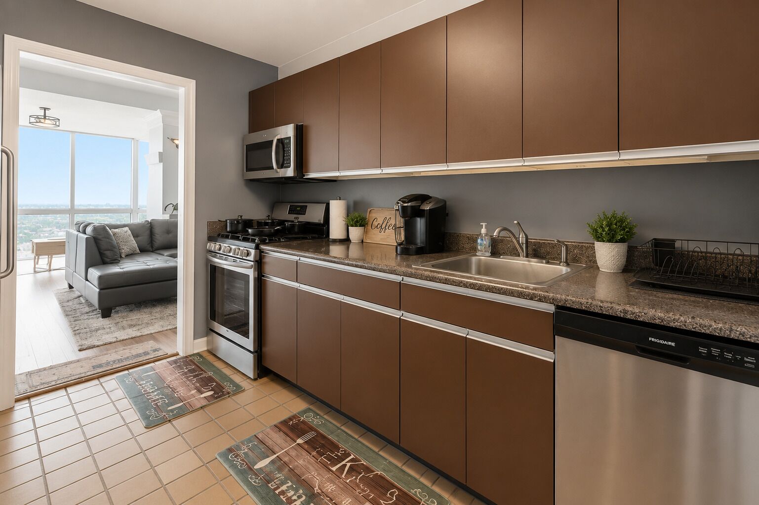 A modern kitchen with stainless steel appliances, a built-in microwave, and a dishwasher.