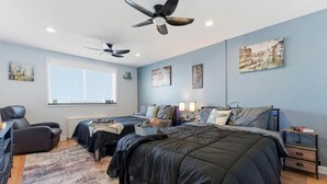 A bedroom with two beds, a desk, a chair, and ceiling fans. - The ATL Sky Suite High-Floor 3BR Downtown Penthouse Stunning City Views (Atlanta)