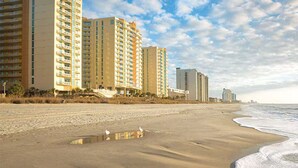A beach with high-rise buildings in the background. - Wyndham 2-BR Deluxe Condo. Sleeps 8, June 20-27th.Ocean View, Full Kitchen (North Myrtle Beach)