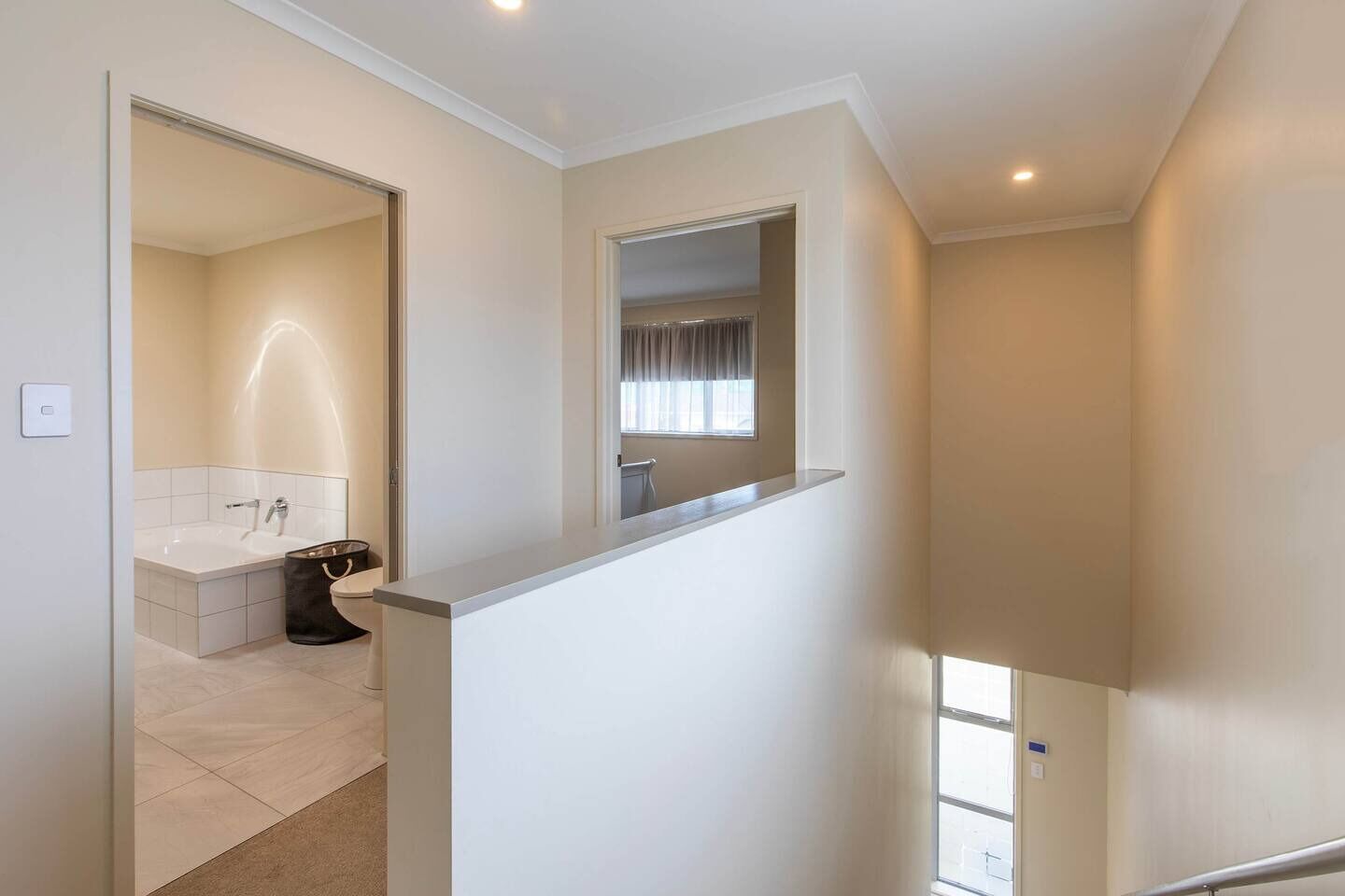 A modern interior with a bathroom featuring a bathtub and a toilet.
