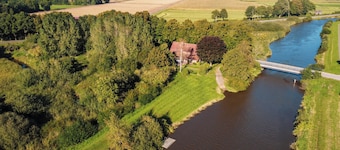 Spacious apartment on the river Aper-Tief directly on the dike in East Frisia
