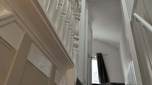 A staircase with white balusters leading to a landing. - Comfortable Stay with Free Parking (Moor Row)