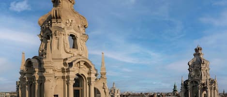 A historic building with ornate architecture, including a prominent dome and detailed carvings.