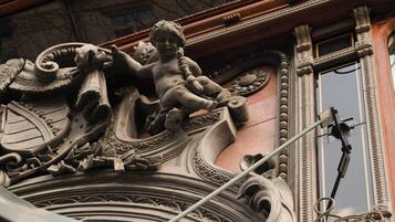 Ornate architectural details with a statue of a child.