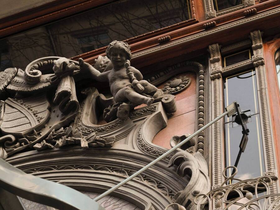 Ornate architectural details with a statue of a child.