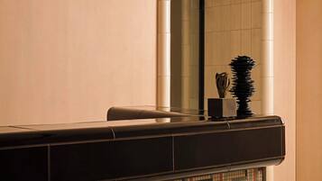 A reception area with a mirror, a reception desk, and a wall with the text 'ST. REGIS SPA'.