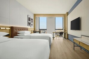 A hotel room with two beds, a desk, a chair, a TV, and a city view. - Four Points By Sheraton Zibo Zichuan (Zibo)