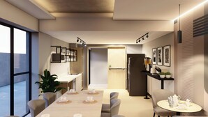 A modern dining area with a long table, chairs, and a small round table with tea set. - City Centro By Marriott Ushuaia Argentina (Ushuaia)