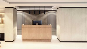 A modern reception area with a wooden reception desk, grey cabinets, and pendant lighting. - City Centro By Marriott Ushuaia Argentina (Ushuaia)