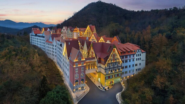 A hotel with a traditional European architectural style, featuring multiple buildings with steeply pitched roofs and a central courtyard. - Fairfield By Marriott Hengdian (Jinhua)