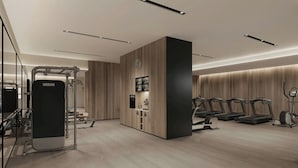 A modern gym with treadmills, a stationary bike, and weightlifting equipment. - Fairfield By Marriott Hengdian (Jinhua)
