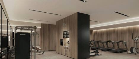 Un gimnasio moderno con cintas de correr, una bicicleta estática y equipo de levantamiento de pesas.