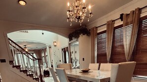 A dining area with a chandelier, wooden flooring, and a view of the kitchen. - Delightful 3-bedroom 2-bathroom Single family home in Springfield (Springfield)