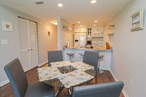 A compact kitchen with white cabinets, a microwave, and a coffee maker. - The view at this Newly Remodeled Townhouse is Amazing! Creston House 6C (St. Augustine)