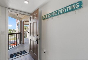 A hotel entrance with a door leading to a balcony. - Ocean Village Club Condo D31 (St. Augustine)