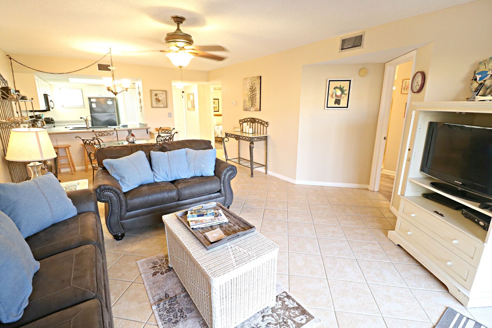A living room with a sofa, coffee table, and TV stand.