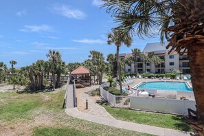 A resort with a swimming pool, palm trees, and a gazebo. - Ocean Village Club Condo Q26 (St. Augustine)