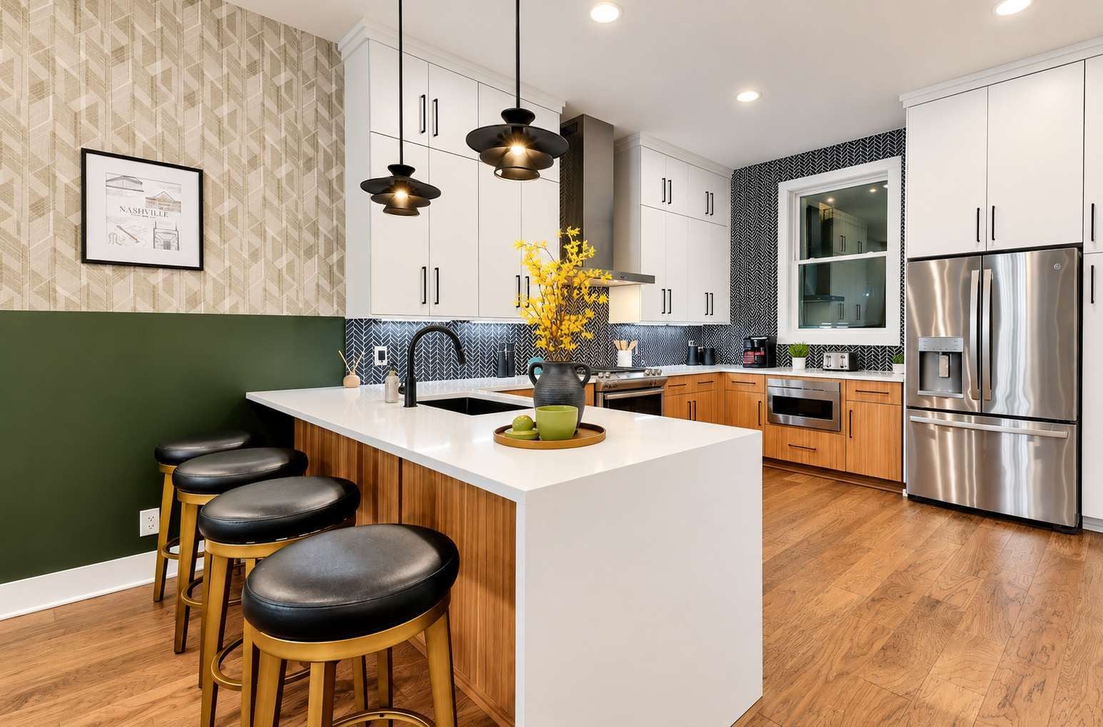 A modern kitchen with a central island, bar stools, stainless steel appliances, and a patterned backsplash.