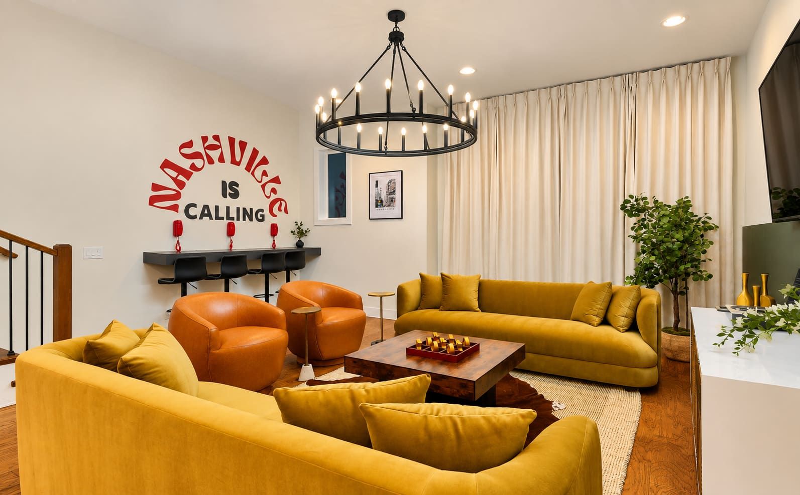 A modern living room with a yellow sofa set, a coffee table, and a chandelier.