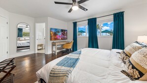 A bedroom with a bed, a desk, a chair, a ceiling fan, and a window with curtains. - Waterfront Stunner! Heated Pool+Spa+Sauna+Firepit+ Playground! (West Palm Beach)