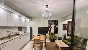A compact living space with a kitchen, dining area, and seating area.