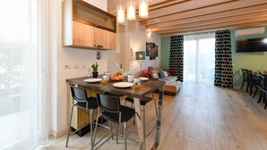 Una cocina moderna con una isla de madera, taburetes de bar e iluminación colgante.