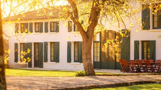 A building with a white facade, green shutters, and a tree in the foreground. - Private estate with swimming pool, garden & open spaces - Up to 12 guests (Bréville)