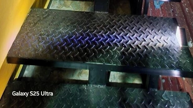 A staircase with metal steps and handrails, leading to an upper level.