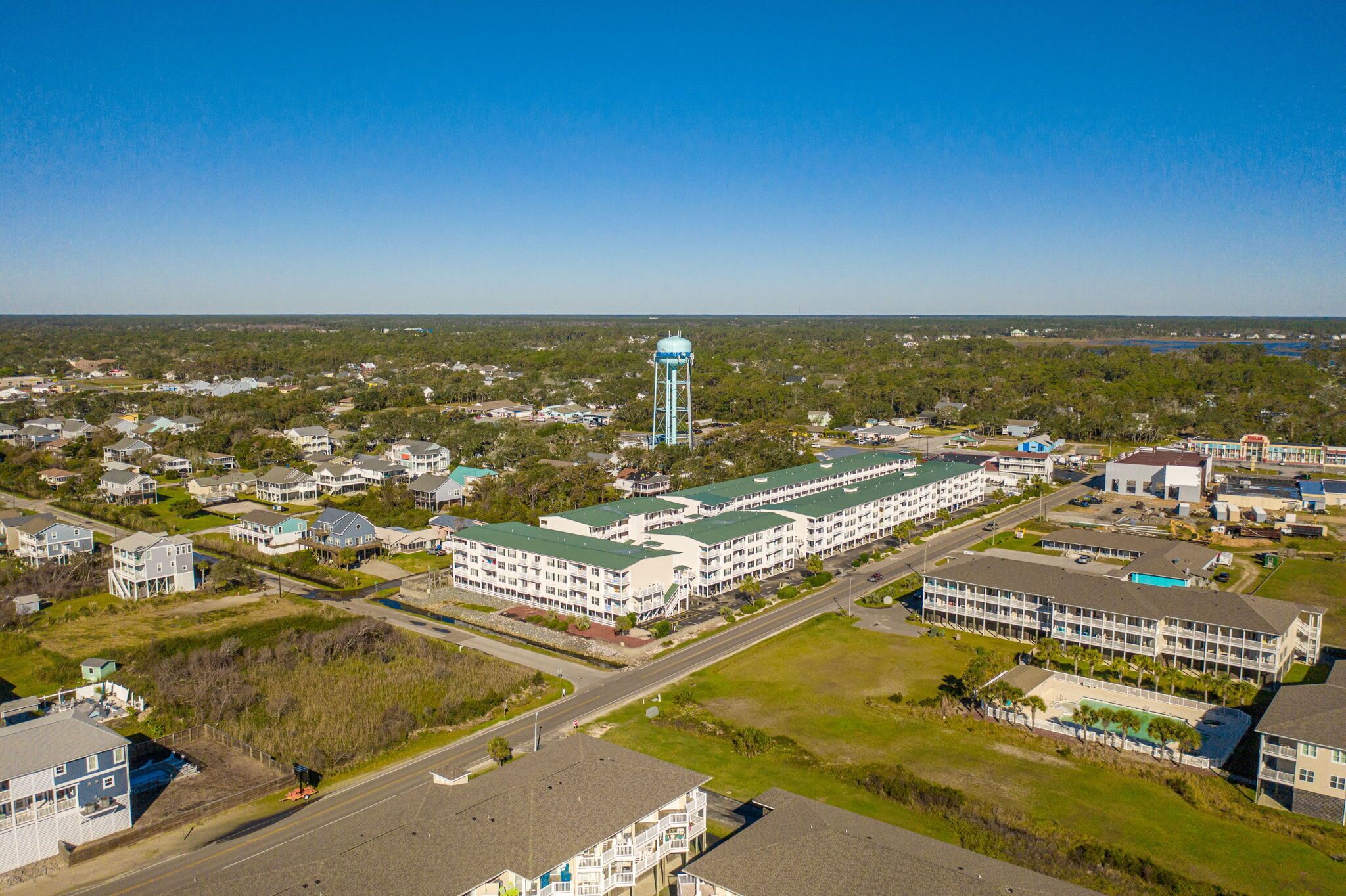 A large hotel with multiple floors and a central water tower.