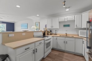 Fridge, microwave, oven, stovetop - Coastal Condo with Community Pool, Steps to Beach! (Oak Island)