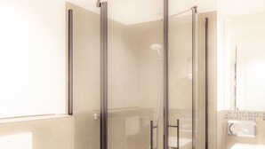 A modern bathroom with a glass-enclosed shower, a toilet, and a sink. - Hotel Zur Feldmühle (Arnsberg)
