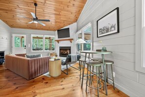 TV, fireplace - Cub Camp - Creekfront Cabin w/ Hot Tub, Fire Pit & Game Barn (Cherry Log)