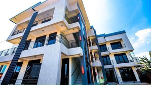 A multi-story building with balconies, staircases, and a clear sky. - ORVENA RESIDENCE (Kigali)