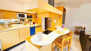 A modern kitchen with a central island, a dining area with chairs, and a living room with a sofa. - Smart Retreat next to Luxembourg Station (Luxembourg City)