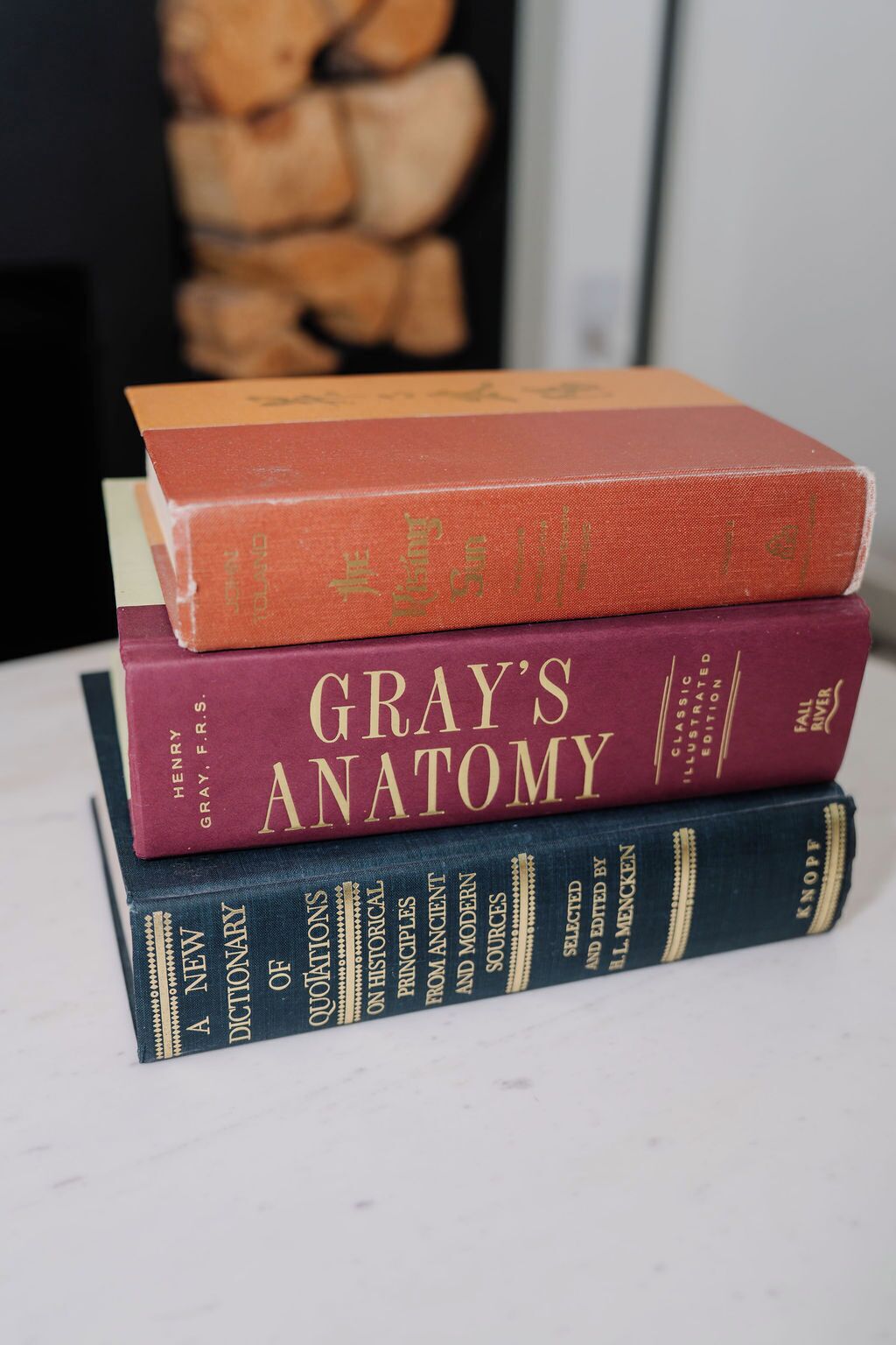 A stack of books on a flat surface.