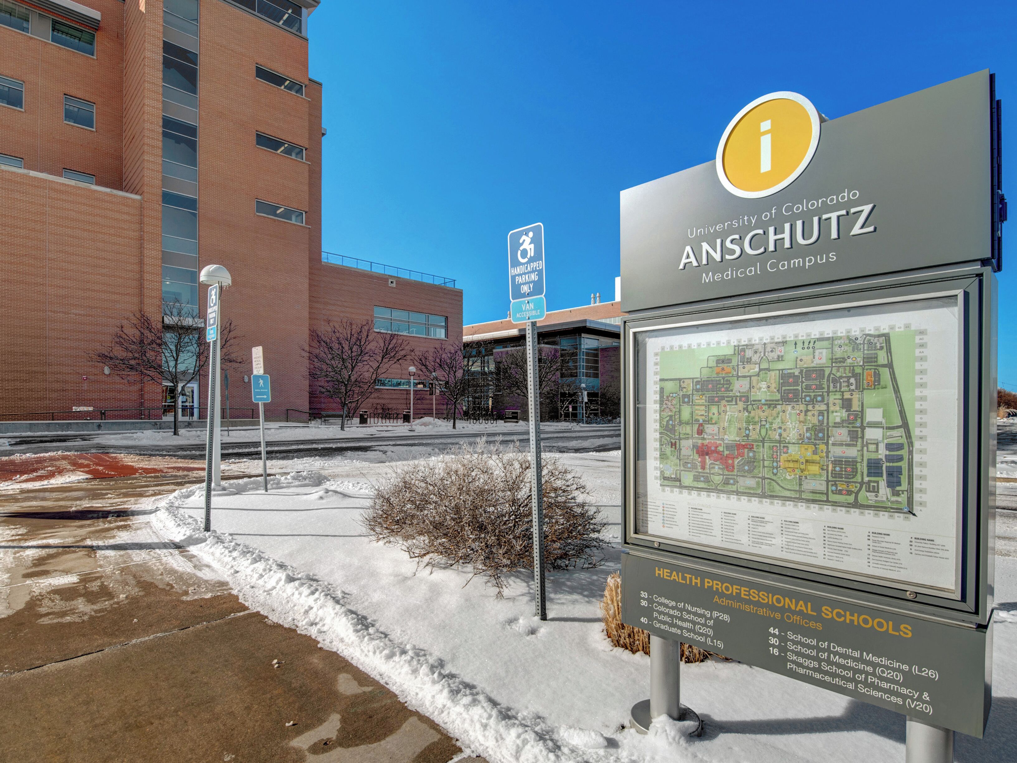 A sign for the University of Colorado Anschutz Medical Campus with a map and list of health professional schools.